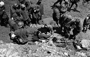 Seriously injured soldier receives comfort from a military chaplain  | Andrea Jemolo