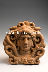Archaeological Deposit Antefix with head of Hercules from sanctuary in location Privati, votive stips - terracotta | Andrea Jemolo