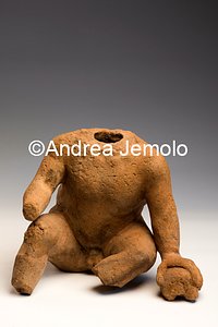 Archaeological Deposit Acephalous figurine of a child from sanctuary of Privati, votive stips - terracotta | Andrea Jemolo