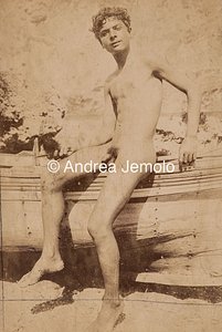  Portrait of naked southern boy leaning on a boat | Andrea Jemolo