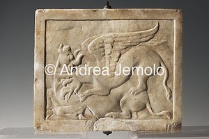 Archaeological National museum Villa of the Mosaic Columns, Pinax side A, votive tablet, with a grifo that assails a bull - from the garden nymphaeum, marble | Andrea Jemolo
