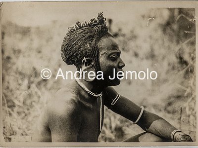 Transafrican expedition Baragiola-Durini Portrait of a young Masai man, with braided hair collected in a typical hairstyle and the ear lobe deformed by a clay disc | Andrea Jemolo