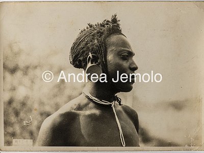 Transafrican expedition Baragiola-Durini Portrait of a young Masai man, with braided hair collected in a typical hairstyle and the ear lobe deformed by a clay disc | Andrea Jemolo
