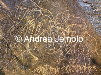  Rock engraving depicting a herd of moving elephants and under a group of men - Tassili n'Ajjer, Tadart Rouge | Andrea Jemolo